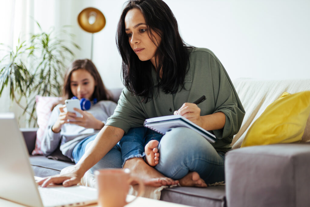 Family on couch with phone and computer