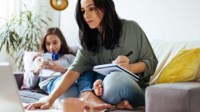 Family on couch with phone and computer